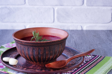 Borsch in brown bowl. Red soup. Dsh of Slavic, Russian, Ukrainian cuisine.