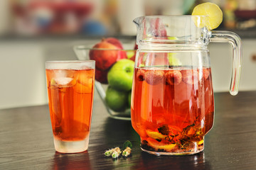 Pitcher and glass of fresh strawberry, mint and lemon slices water.