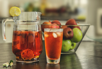 Pitcher and glass of fresh strawberry, mint and lemon slices water.