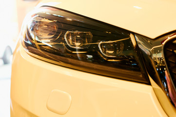 automobile headlights of new modern car. yellow warm tones