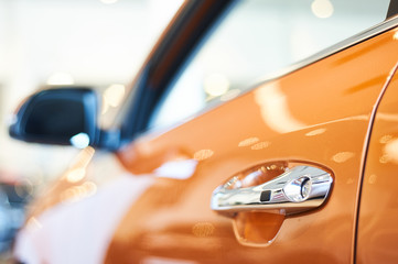 chrome metallic handle of new orange car