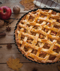 Homemade apple pie on wooden background, top view