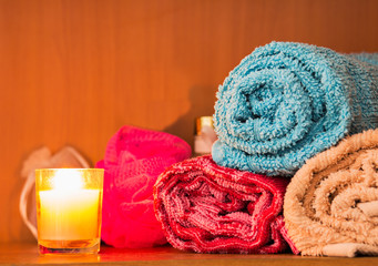 Rolled towels with aromatic candle.