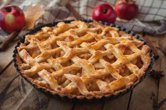 Close-up of homemade apple pie on wooden background