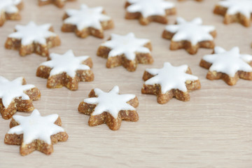 Fototapeta na wymiar cinnamon stars lying on wood