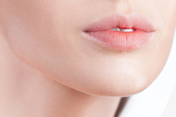 Plump sensual lips of young beautiful woman close up