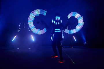 Laser show performance, dancers in led suits with LED lamp, very beautiful night club performance, party