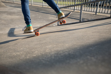 Skateboarder skateboarding at skatepark