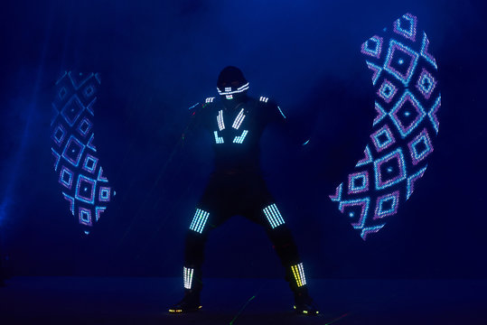 Laser show performance, dancers in led suits with LED lamp, very beautiful night club performance, party