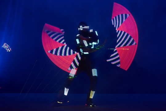 Laser show performance, dancers in led suits with LED lamp, very beautiful night club performance, party