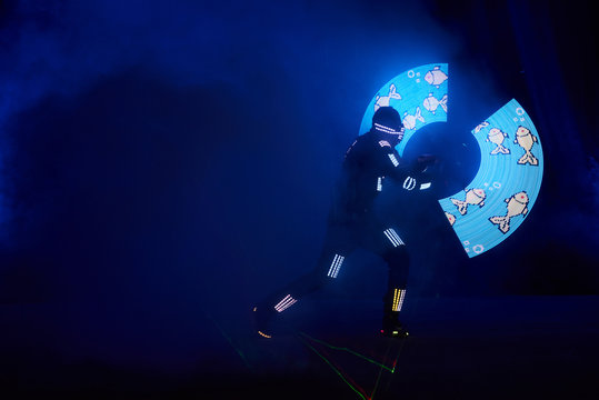 Laser show performance, dancers in led suits with LED lamp, very beautiful night club performance, party
