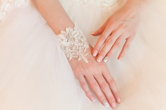 Hands Of The Bride With A Beautiful Manicure And A Bracelet Made Of Lace And Rhinestones Closeup