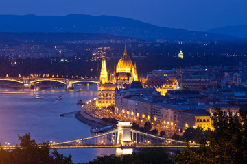 Fototapeta na wymiar travel and european tourism concept. Budapest, Hungary. Hungarian Parliament Building over Danube River and Szechenyi chain bridge illuminated at night.