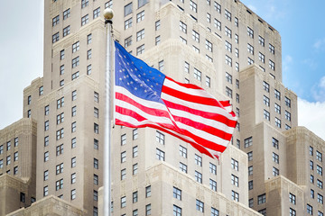 American flag with an old building in background, New York City, USA.