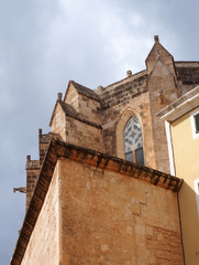 Fototapeta na wymiar detail corner view of santa maria cathedral in la ciutadella in menorca looking upwards with blue summer sky