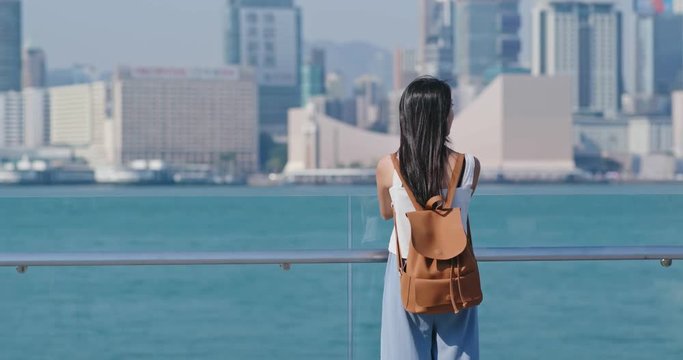 Woman look at the view of kowloon  in Hong Kong