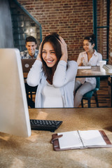 young woman celebrate success at work pointing on his laptop. startup