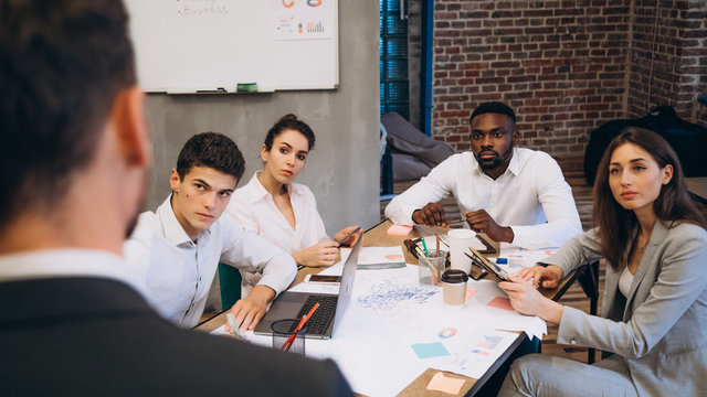 Business conference. Business meeting. Business people in formalwear discussing something while sitting together at the table. startup