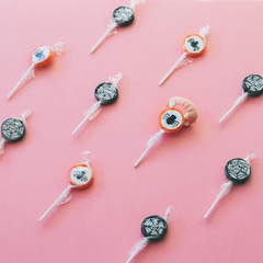 Lollipops with cobweb and spiders and vampire fangs candy. Geometry Halloween concept