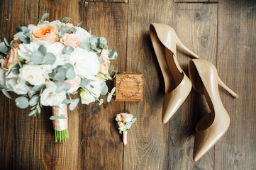 Wedding shoes of the bride together with a bouquet of natural flowers