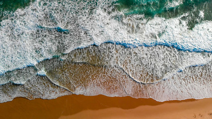 Fototapeta na wymiar Ocean waves overhead aerial view on a sunny day