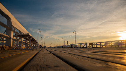 The Sopot Pier in the city of Sopot. The pier is the longest wooden pier in Europe. Beautiful sunrise. - obrazy, fototapety, plakaty