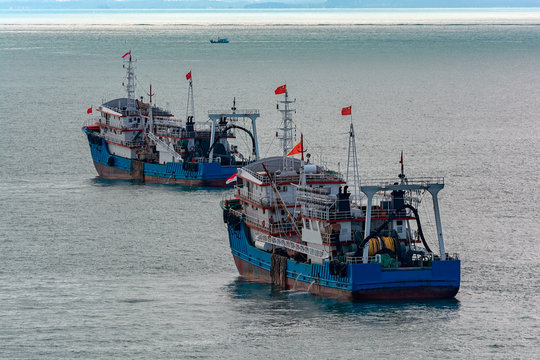 Chinese commercial trawlers anchored on the outer anchorage.