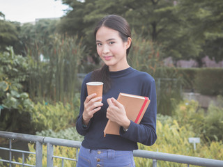 beautiful young Asia woman with reading book at outdoor garden.