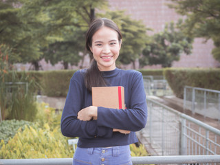 beautiful young Asia woman with reading book at outdoor garden.