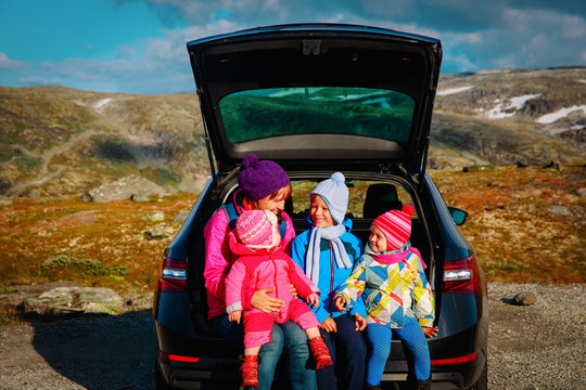 mother with kids enjoy travel by car in nature