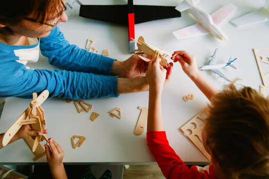 teacher and kids making toy planes, learning concept