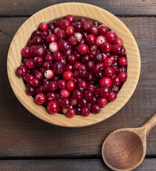 red berries of ripe lingonberries in a wooden bowl