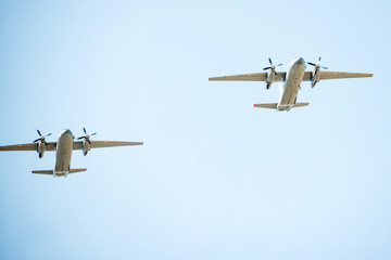 Military airplanes fly in the blue sky