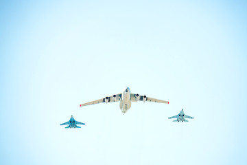 Military airplanes fly in the blue sky