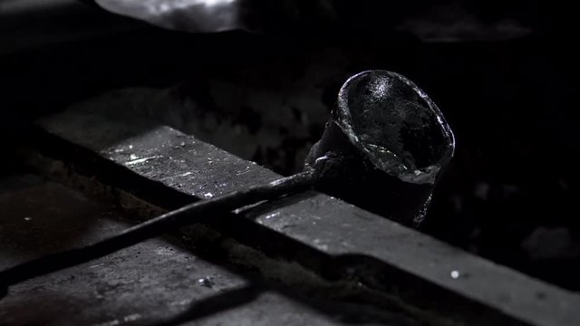 Master Puts A Small Iron Ladle With A Long Handle
