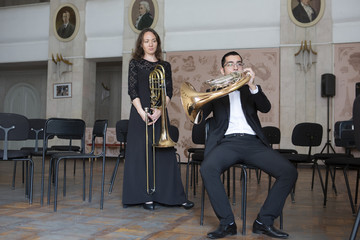 Two musicians playing on wind instruments