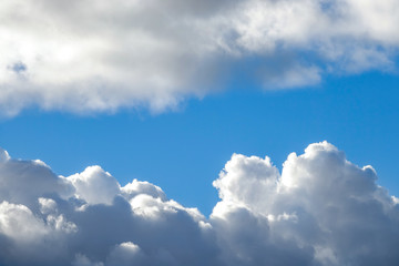 Naklejka na ściany i meble Beautiful white fluffy clouds and blue sky. Fullscreen background texture.