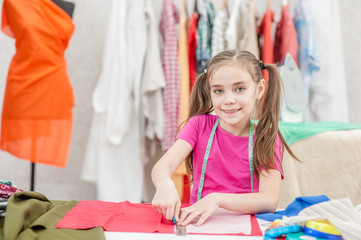 Happy little girl draws with soap markup patterns. Space for text