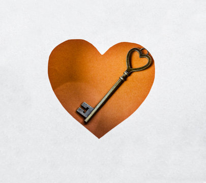 Vintage key on heart paper.
