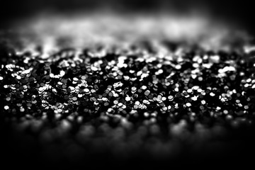 Abstract black glitter background, shallow depth of field.