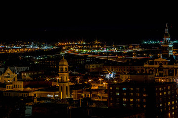 Night aerial view of historic buildings courthouse towers and highway lights