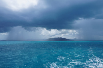 Fototapeta na wymiar Passing showers over the ocean