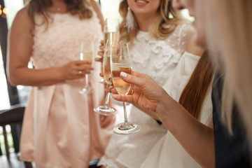 Girls party. Girls cheers glasses with champagne in restraunt