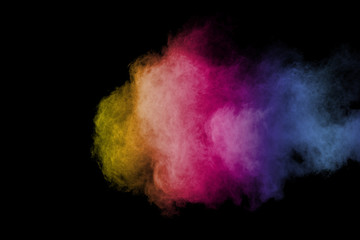 Abstract powder splatted background. Colorful powder explosion on black background. Colored cloud....