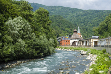 Fototapeta na wymiar fast river in the Caucasus mountains in the town of Rosa Khutor