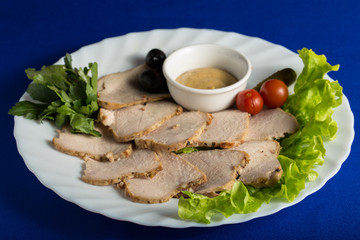 Meat with greens isolated on blue