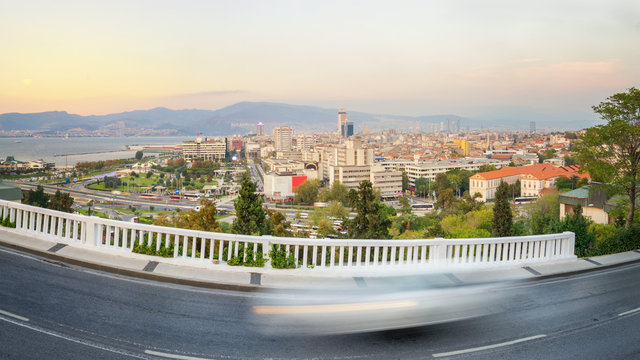Panoramic view of Izmir Turkey. View from Varyant district with a blurred car 