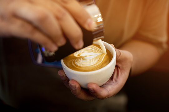 Barista made latte art in heart shape.