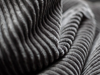 Closeup of folds of dark grey fabric