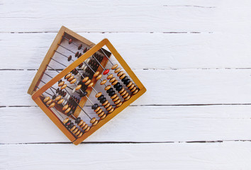 Vintage wooden abacus on old board surface.